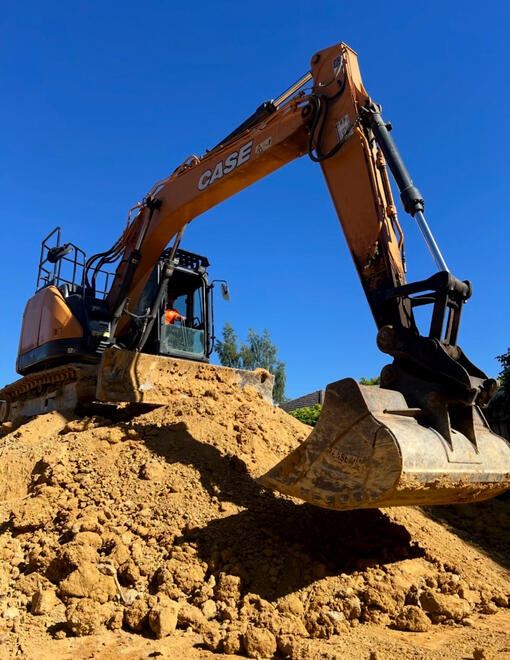 Excavator loading soil into a truck for earthmoving by All Equipped Plant Hire.